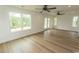 Bright living room boasts hardwood floors, neutral walls, a ceiling fan and windows offering a view of the outdoors at 2212 Dykman Circle, Little River, SC 29566