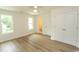 Bright main bedroom featuring wood-look floors, natural light, and a closet for storage at 2212 Dykman Circle, Little River, SC 29566