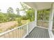 Covered porch showcasing marsh views, featuring white railing and gray decking at 2212 Dykman Circle, Little River, SC 29566
