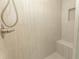 Detail of the shower, featuring a handheld shower head, built-in bench and tiled walls at 2212 Dykman Circle, Little River, SC 29566