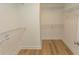 Walk-in closet featuring hardwood floors and white wire shelving at 2212 Dykman Circle, Little River, SC 29566