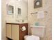 Bathroom featuring floral wallpaper, white toilet, single vanity with two-door cabinet, and mirrored medicine cabinet at 223 Maison Dr. # D-16, Myrtle Beach, SC 29572