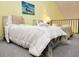 Bright bedroom featuring beds with fresh white bedding and a sitting area in the loft at 223 Maison Dr. # D-16, Myrtle Beach, SC 29572