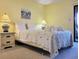 Cozy bedroom with a queen bed, two nightstands, and a sliding door to the balcony at 223 Maison Dr. # D-16, Myrtle Beach, SC 29572