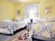 Well-lit bedroom with two beds, a nightstand, and comfortable bedding at 223 Maison Dr. # D-16, Myrtle Beach, SC 29572