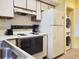 Efficient kitchen featuring appliances, white cabinets, and a stainless steel sink at 223 Maison Dr. # D-16, Myrtle Beach, SC 29572