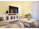 Comfortable living room with a large TV, console, sofa, and armchair at 223 Maison Dr. # D-16, Myrtle Beach, SC 29572