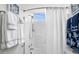 Bright bathroom featuring a clean shower and decorative nautical themed decor and towels at 2262 Andover Dr. # E, Surfside Beach, SC 29575