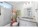 Well-lit bathroom with a tub, granite countertop and colorful shower curtain at 2262 Andover Dr. # E, Surfside Beach, SC 29575