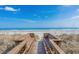 Inviting boardwalk leading to a beautiful beach with calm waters and clear skies at 2262 Andover Dr. # E, Surfside Beach, SC 29575
