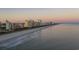 Stunning beachfront skyline at sunset featuring hotels and condos along the sandy shoreline at 2262 Andover Dr. # E, Surfside Beach, SC 29575