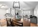Open dining area with seating for four, hardwood floors and kitchen view at 2262 Andover Dr. # E, Surfside Beach, SC 29575