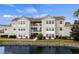 Beautiful condo complex with pond, landscaping, and balconies on a sunny day at 2262 Andover Dr. # E, Surfside Beach, SC 29575