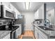 Galley kitchen featuring stainless appliances and granite countertops at 2262 Andover Dr. # E, Surfside Beach, SC 29575