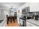 Charming kitchen with stainless appliances and adjacent dining area at 2262 Andover Dr. # E, Surfside Beach, SC 29575