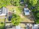 Aerial view of a large fenced-in backyard with lush greenery, a storage shed and a seating area at 228 Hopeland St., Pawleys Island, SC 29585