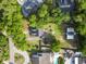 Aerial view of a home with a spacious yard and nearby community amenities surrounded by trees at 228 Hopeland St., Pawleys Island, SC 29585