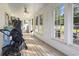 Bright back porch featuring wood floors and a view of the backyard at 228 Hopeland St., Pawleys Island, SC 29585