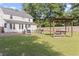 Large backyard with patio, swing, grill, and lush greenery for outdoor enjoyment at 228 Hopeland St., Pawleys Island, SC 29585