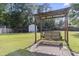 Inviting backyard retreat with a charming wooden swing and ample space for outdoor enjoyment at 228 Hopeland St., Pawleys Island, SC 29585