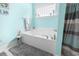Relaxing tub with jets, a gray rug, and decorative accents create a spa-like atmosphere at 228 Hopeland St., Pawleys Island, SC 29585