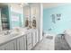 Bright bathroom with double vanity, turquoise walls, and unique decorative touches at 228 Hopeland St., Pawleys Island, SC 29585
