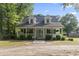 Charming home with a welcoming front porch and well-manicured landscaping at 228 Hopeland St., Pawleys Island, SC 29585