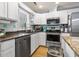 Bright eat-in kitchen featuring stainless steel appliances, tile backsplash, and hardwood floors at 228 Hopeland St., Pawleys Island, SC 29585
