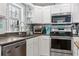 Eat-in kitchen featuring stainless steel appliances, granite countertops, and hardwood floors at 228 Hopeland St., Pawleys Island, SC 29585