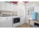 A spacious laundry room featuring washer, dryer, and storage cabinets at 228 Hopeland St., Pawleys Island, SC 29585