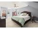 This spacious bedroom features a ceiling fan, carpet, and light grey paint at 228 Hopeland St., Pawleys Island, SC 29585
