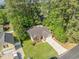 Overhead aerial shot of a brick home with well manicured lawn surrounded by mature trees at 2405 Brick Dr., Longs, SC 29568