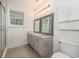 Bathroom with double sinks, granite countertop and white-paneled walls at 2405 Brick Dr., Longs, SC 29568