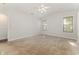 Spacious bedroom with neutral carpeting, white walls, ceiling fan and two windows allowing plenty of light at 2405 Brick Dr., Longs, SC 29568