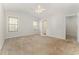Spacious bedroom features neutral carpeting, two windows and a ceiling fan at 2405 Brick Dr., Longs, SC 29568