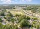 An aerial view of homes in a wooded, golf course community, dotted with ponds and green spaces at 2405 Brick Dr., Longs, SC 29568