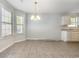 Bright dining area featuring tile floors, a modern light fixture, and large windows that provide lots of natural light at 2405 Brick Dr., Longs, SC 29568
