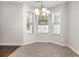 Bright dining area featuring tile floors, a modern light fixture, and large windows that provide lots of natural light at 2405 Brick Dr., Longs, SC 29568