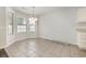 Bright dining area featuring tile floors, a modern light fixture, and large windows that provide lots of natural light at 2405 Brick Dr., Longs, SC 29568