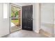 Foyer view looking out to the front yard, showing the tiled floors and black door at 2405 Brick Dr., Longs, SC 29568