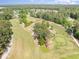 Overhead aerial shot of a golf course with mature trees and ponds between the fairways at 2405 Brick Dr., Longs, SC 29568