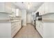 Bright kitchen featuring tile floors, stainless steel appliances, and white cabinets at 2405 Brick Dr., Longs, SC 29568