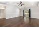 Bright living room with dark hardwood floors, ceiling fan, and sliding glass door at 2405 Brick Dr., Longs, SC 29568