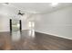 Large, open-concept living area with dark wood floors, ceiling fan, and lots of natural light at 2405 Brick Dr., Longs, SC 29568
