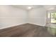 Inviting living room boasts sleek hardwood floors and ample natural light from the glass paneled front door at 2405 Brick Dr., Longs, SC 29568