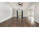 Spacious living room with dark wood floors, a ceiling fan, and large windows at 2405 Brick Dr., Longs, SC 29568