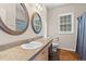 Well-lit bathroom with a vanity, framed mirror, and a tiled floor at 265 South Causeway Rd., Pawleys Island, SC 29585