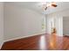 Bright and airy bedroom featuring a ceiling fan, wood floors, and access to the bathroom at 265 South Causeway Rd., Pawleys Island, SC 29585
