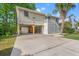 Inviting raised beach home featuring a large driveway, carport, and charming exterior details at 265 South Causeway Rd., Pawleys Island, SC 29585