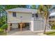 Charming raised beach home with carport, stairs to porch and decorative crab at 265 South Causeway Rd., Pawleys Island, SC 29585